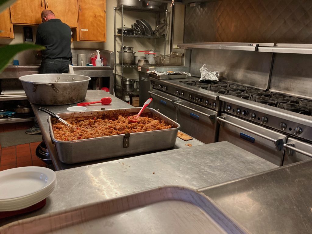 The commercial-grade kitchen incudes 12 burners, 4 ovens, a deep-fryer, a griddle, spacious refrigerator and a service window to the main hall.